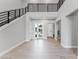 Bright foyer featuring soaring ceilings, modern black railings, and stylish tile flooring at 15942 Vetta Dr, Bella Collina, FL 34756