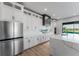 Modern kitchen with white cabinets, a large island, stainless steel appliances, and plenty of counter space at 15942 Vetta Dr, Bella Collina, FL 34756