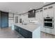 Well-equipped kitchen featuring stainless steel appliances, custom cabinets, and a large island with seating at 15942 Vetta Dr, Bella Collina, FL 34756