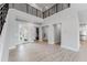 Expansive open-concept living area featuring sleek tile flooring and seamless transitions to the kitchen at 15942 Vetta Dr, Bella Collina, FL 34756