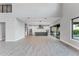 Spacious open-concept living area featuring sleek tile flooring and seamless transitions to the kitchen and dining at 15942 Vetta Dr, Bella Collina, FL 34756