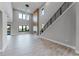 This large living space boasts a modern fireplace and staircase with plenty of natural light from the high windows at 15942 Vetta Dr, Bella Collina, FL 34756
