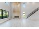 Spacious living room with a modern fireplace, high ceilings, and beautiful hardwood floors at 15942 Vetta Dr, Bella Collina, FL 34756