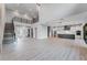 Open floor plan combining living, dining, and kitchen areas with hardwood floors and natural light at 15942 Vetta Dr, Bella Collina, FL 34756