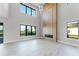 Living room area with fireplace and large windows offering great views and natural lighting at 15942 Vetta Dr, Bella Collina, FL 34756