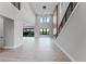 Large living room featuring hardwood floors, tall ceilings, a staircase, and plentiful natural light at 15942 Vetta Dr, Bella Collina, FL 34756