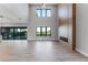 Bright, spacious living room featuring wood floors, fireplace, and an abundance of natural light from large windows at 15942 Vetta Dr, Bella Collina, FL 34756