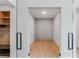 Office space featuring sleek wood floors, decorative paneling, and convenient access to the mudroom at 15942 Vetta Dr, Bella Collina, FL 34756