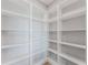 Walk-in pantry featuring ample shelving for storage and organization at 15942 Vetta Dr, Bella Collina, FL 34756