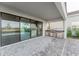 Spacious outdoor patio with sliding glass doors and a built-in kitchen at 15942 Vetta Dr, Bella Collina, FL 34756