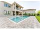 Beautiful backyard with a private pool, patio, and outdoor kitchen at 15942 Vetta Dr, Bella Collina, FL 34756