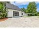 Exterior view of backyard with patio, lush landscaping, and attached carport at 1660 Justin Matthew Way, St Cloud, FL 34771