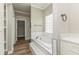 Bright bathroom with a soaking tub, white tile, and modern fixtures at 1660 Justin Matthew Way, St Cloud, FL 34771