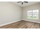 Cozy bedroom with ceiling fan and a large window overlooking the front yard at 1660 Justin Matthew Way, St Cloud, FL 34771