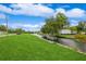 Waterfront view of a canal on a bright, sunny day with blue skies and green landscaping at 1660 Justin Matthew Way, St Cloud, FL 34771