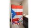 Bathroom with Puerto Rico themed shower curtain and matching rug and toilet seat cover at 16863 Sw 29Th Terrace Rd, Ocala, FL 34473