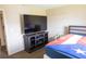 Bedroom with a modern TV stand and large flat screen tv on the wall at 16863 Sw 29Th Terrace Rd, Ocala, FL 34473