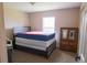Bedroom with carpeted floors, a window for natural light, and a bed with Puerto Rican themed blankets at 16863 Sw 29Th Terrace Rd, Ocala, FL 34473