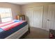 Bedroom with a modern closet, carpeted floors, and a bed with Puerto Rican themed blankets at 16863 Sw 29Th Terrace Rd, Ocala, FL 34473
