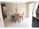 Bright dining area features a round table with seating for four, with light-colored tile floors and window with natural light at 16863 Sw 29Th Terrace Rd, Ocala, FL 34473