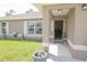 Inviting front porch with welcome sign, lush green lawn, and attractive neutral exterior at 16863 Sw 29Th Terrace Rd, Ocala, FL 34473