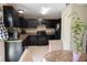 Stylish kitchen with dark cabinetry with adjacent dining area at 16863 Sw 29Th Terrace Rd, Ocala, FL 34473