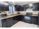 Modern kitchen with dark cabinetry and stainless steel appliances at 16863 Sw 29Th Terrace Rd, Ocala, FL 34473