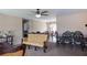 Open-concept living space featuring ceiling fan, plush carpet, and vintage-style furnishings at 16863 Sw 29Th Terrace Rd, Ocala, FL 34473