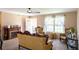 Inviting living room featuring a decorative fireplace, classic furnishings, and a bright window at 16863 Sw 29Th Terrace Rd, Ocala, FL 34473