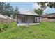 Exterior view of the home's screened-in lanai and backyard at 1802 Waterbeach Ct, Apopka, FL 32703
