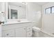 All-white bathroom features shower, vanity, mirror and window at 1802 Waterbeach Ct, Apopka, FL 32703