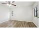 Bedroom with wood floors, ceiling fan and windows offering natural light at 1802 Waterbeach Ct, Apopka, FL 32703