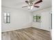 Bedroom with wood-look flooring and natural light from two windows at 1802 Waterbeach Ct, Apopka, FL 32703