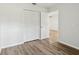 Bedroom featuring wood floors, closet and doorway with modern trim at 1802 Waterbeach Ct, Apopka, FL 32703