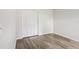 Bedroom with wood floors, closet with modern trim and natural light at 1802 Waterbeach Ct, Apopka, FL 32703