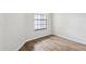 Cozy bedroom with wood floors and a window providing natural light at 1802 Waterbeach Ct, Apopka, FL 32703