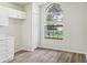 Light-filled bonus room with wood floors, large window and built-in cabinets at 1802 Waterbeach Ct, Apopka, FL 32703