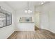 Bright dining area featuring wood floors, pass through and chandelier lighting at 1802 Waterbeach Ct, Apopka, FL 32703