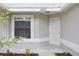 Close up of home's front entrance and the window to the left, painted in neutral color scheme at 1802 Waterbeach Ct, Apopka, FL 32703