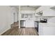 The remodeled kitchen showcases stainless appliances, white cabinets, modern countertops, and durable floors at 1802 Waterbeach Ct, Apopka, FL 32703