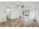 Bright and airy living room featuring wood-look flooring, a ceiling fan, and sliding glass doors at 1802 Waterbeach Ct, Apopka, FL 32703