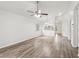 Open-concept living room boasts wood-look floors, vaulted ceilings and seamlessly connects to other rooms at 1802 Waterbeach Ct, Apopka, FL 32703