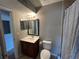 Neutral toned bathroom with a single sink vanity and a toilet in the corner at 1922 Conway Rd # 1922, Orlando, FL 32812