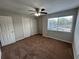 Bedroom with carpet, ceiling fan, closet, and bright window views at 1922 Conway Rd # 1922, Orlando, FL 32812