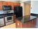 Kitchen with granite countertops, wooden cabinets, and stainless steel appliances at 1922 Conway Rd # 1922, Orlando, FL 32812