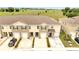 Townhome exteriors with attached garages, enhanced by landscaping and contemporary design features at 200 Feltrim Reserve Blvd, Davenport, FL 33837