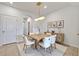 Bright dining area with modern light fixture, seating for six, and contemporary decor at 200 Feltrim Reserve Blvd, Davenport, FL 33837