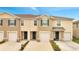 Townhome exterior showcasing individual garages, welcoming entryways, and neatly maintained landscaping at 200 Feltrim Reserve Blvd, Davenport, FL 33837