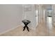 Hallway with tile floor, a charming sailboat decoration, and entry to rooms on either side at 200 Feltrim Reserve Blvd, Davenport, FL 33837