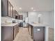 This kitchen features dark cabinets, stainless steel appliances, and a large island for food preparation at 200 Feltrim Reserve Blvd, Davenport, FL 33837
